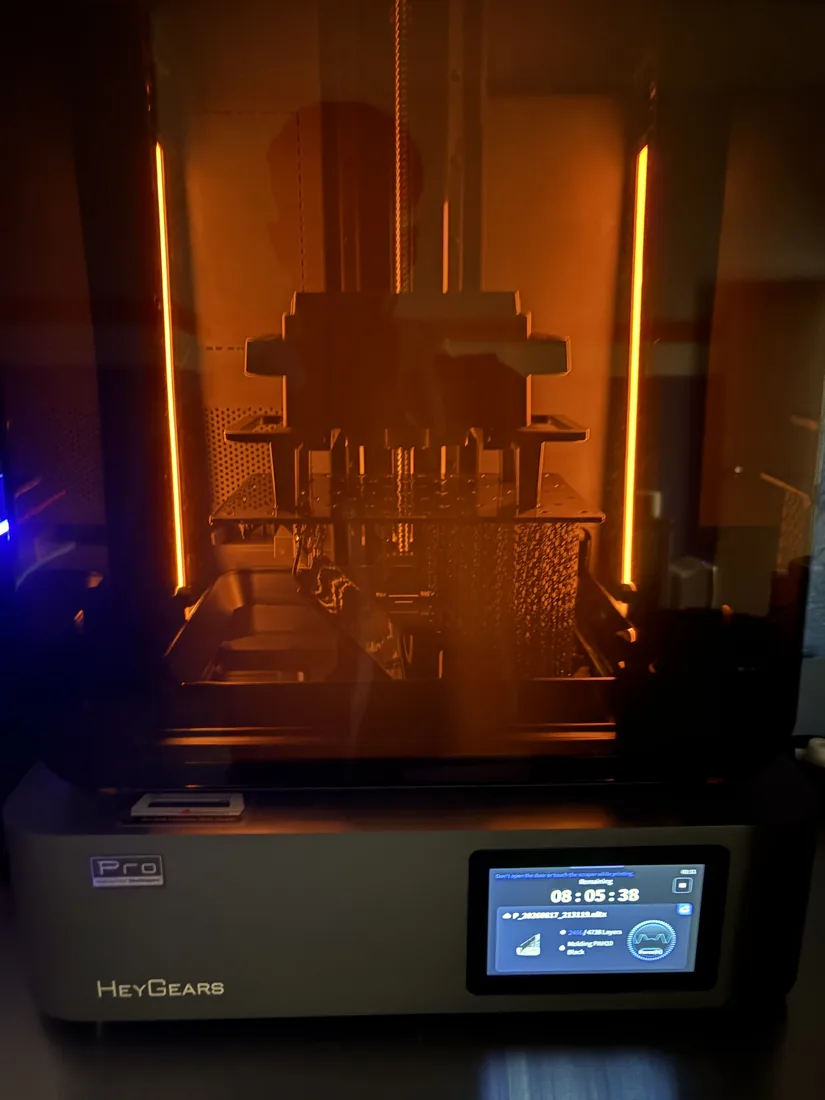 SLA resin printer mid-print with parts on the build plate